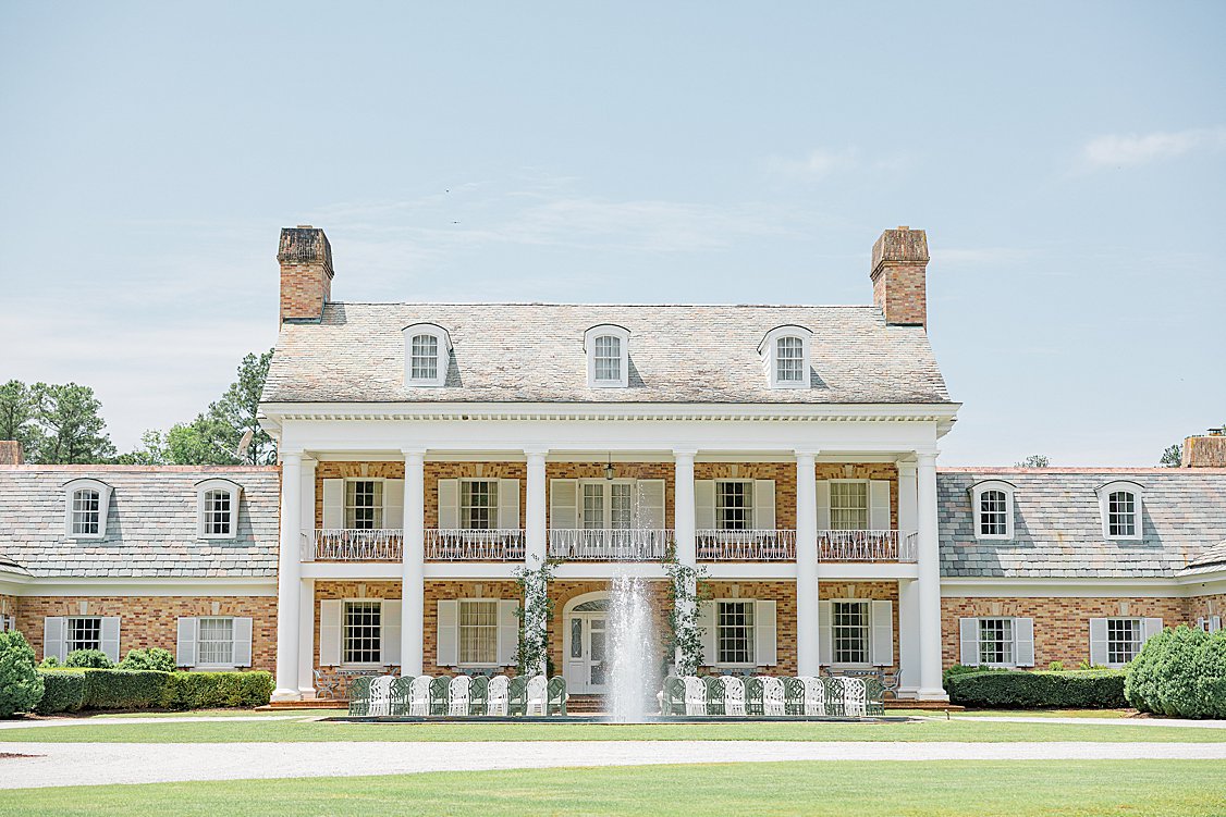 Ceremony with custom lined green and white chairs.