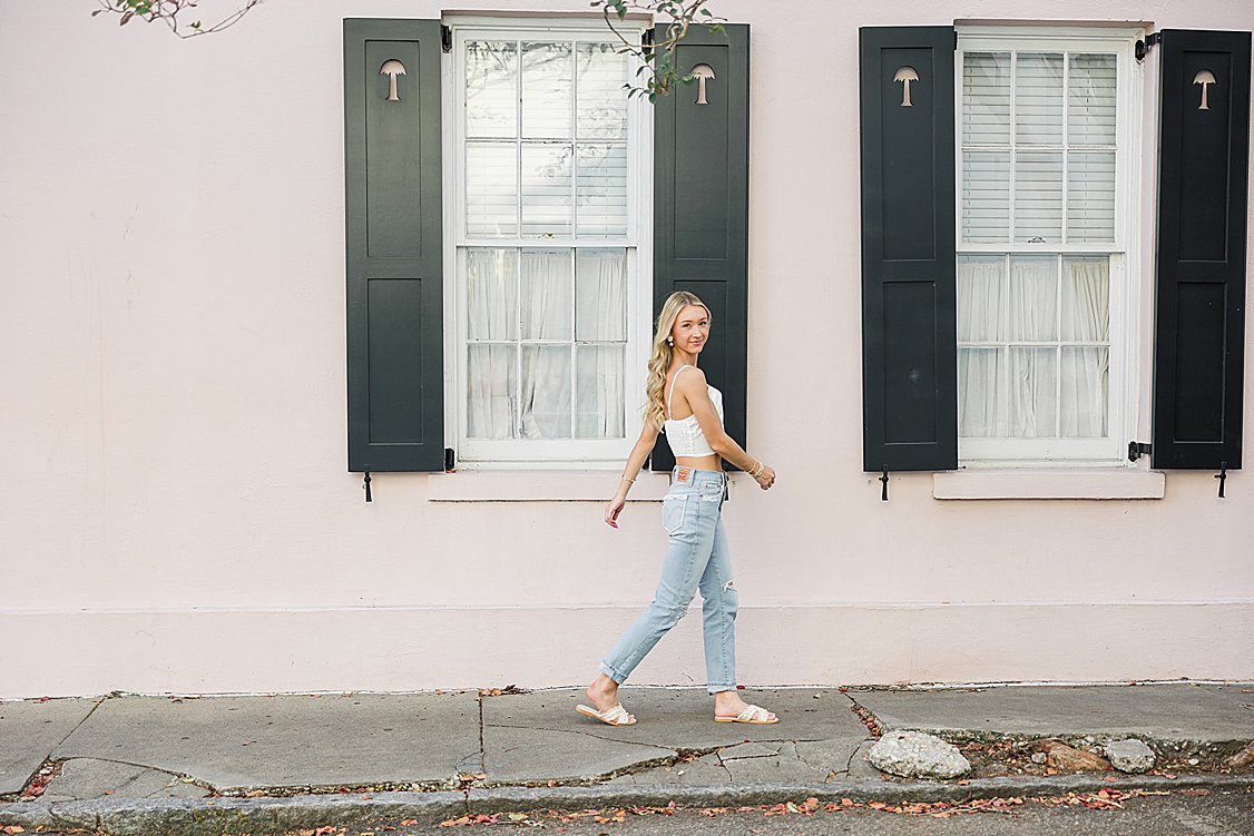 Brooke’s senior portrait in front of the colorful historic homes of Rainbow Row in downtown Charleston, SC.