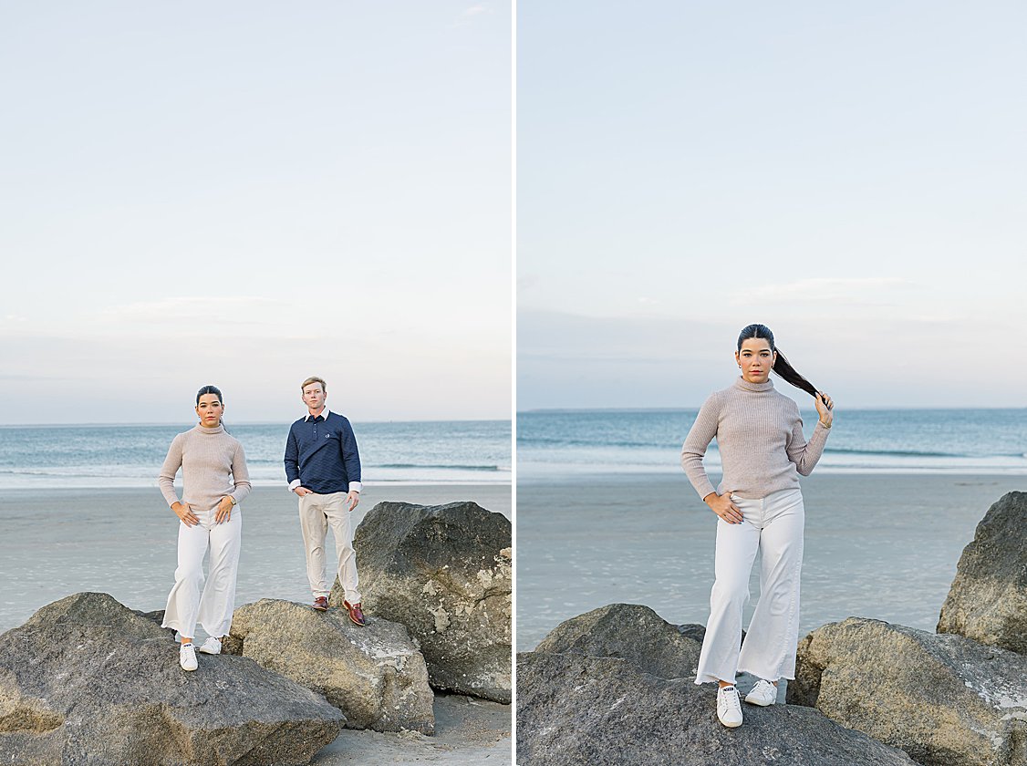 Couple walking hand in hand along Tybee Island beach at sunset, dressed in soft coastal chic attire.