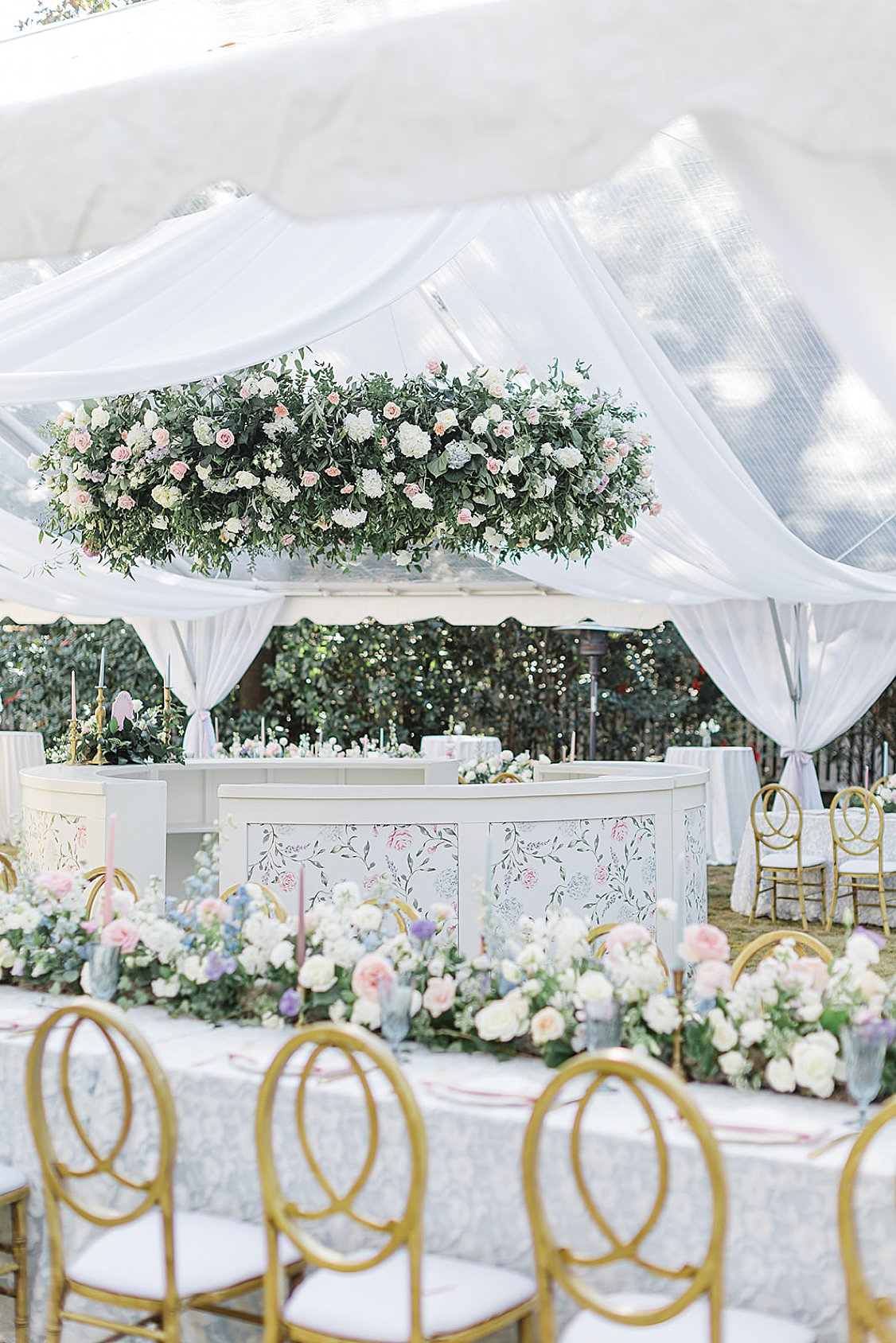 Custom 360-degree wedding bar at a private estate reception, styled with flowers and elegant design elements.