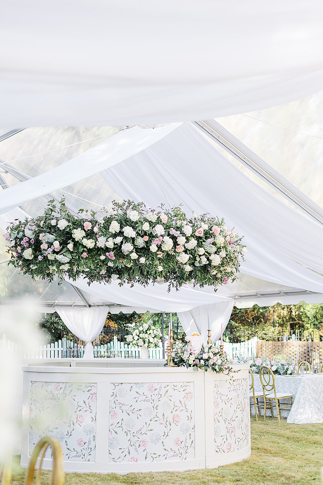 Custom 360-degree wedding bar at a private estate reception, styled with flowers and elegant design elements.